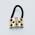 Detail of black elastic hair tie with golden alloy star cutout metal ornament - Hollow Star (Hair Tie 65)