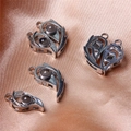 Detailed close-up of four silver magnetic heart pendants with dark projection stones - Hollow Heart Projection Stone