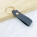 Minimalist deep blue PU leather keychain with a golden metal ring on a wooden surface - No.5 Dark Grey