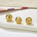 Macro view of gold hollow round alloy beads with gender symbols for jewelry DIY - Style 18