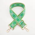 Close-up of jacquard woven strap with green geometric patterns and gold metal clips - Green Blue Floral