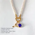 Elegant pearl necklace with textured gold letter A and royal blue crystal pendant - Letter Y