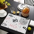 Pink and black HO HO HO Christmas placemat with stars on black wood table - CD57-23
