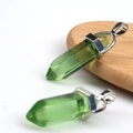 Double pointed hexagonal green crystal pillar pendant with silver clasp on wood disk - Transparent Green