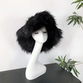 Chic black faux fur winter hat in punk style on minimalist white display stand - Black