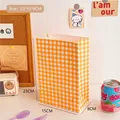 Yellow and white checkered kraft paper gift bag measuring 23x15x8cm in a cozy setup - 4# Orange Plaid Paper Bag