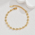 Macro view of gold-plated stainless steel flower bracelet with turquoise blue oil drip - Blue Flower Bracelet