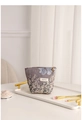 Dettaglio trousse in jacquard floreale con cerniera a fiore dorata su vassoio - Grigio-Viola Con Fiori Bianchi
