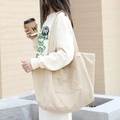 Minimalist beige corduroy tote bag featuring a spacious front pocket and wide shoulder strap - Khaki