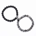 Close-up of magnetic heart clasp connecting matte black and white turquoise stone bracelets - Map Stone And Matte Stone