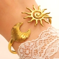 Golden stainless steel celestial cuff bracelet featuring sun and moon charms for women - Sun Moon Astrology (12029)