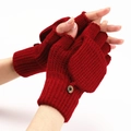 Detail of dark red knitted fingerless gloves with a practical fold-over flap and button - One Size / Red