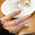 Pink cat eye stone heart necklace with silver bowknot pendant on hand display - Pink Cat Eye Stone Bow Heart Pendant (X1079 Silver)