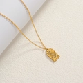 Detail of 18K gold-plated starburst pendant with sparkling zircon on textured background - Gold-Zirconia Sunburst Square Pendant