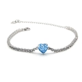Detailed macro of S925 heart charm and blue zircon bracelet with white cubic zirconia - Blue