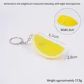 Yellow PVC artificial lemon slice keychain with silver metal clasp on white background - Yellow Lemon Block - Keychain