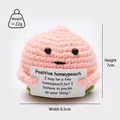 Detail view of a handmade crochet peach doll with dimensions: 7cm height and 8.5cm width - Peach P Card