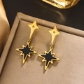 Macro shot of 18K gold plated star earrings with black shell inlay on a gold metal tray - Gold E-395 (Black Eight-Pointed Star)
