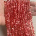 Polished red translucent crystal beads in a vertical string for DIY jewelry making - Watermelon Red K9 Glass