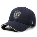 Dark blue baseball cap with shield embroidery and contrasting brown brim detail - Navy Blue
