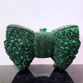 Detailed view of luxury green bow clutch bag with shimmering crystals and rhinestone knots - Green / Gunmetal Hardware
