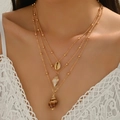 Golden multi-layer necklace featuring starfish and seashell pendants with pearl details - Gold Conch Series