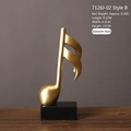 Ornamento in resina a forma di semicroma dorata con base nera per arredo casa - Semicroma Stile B / 6.1x4.3x15cm
