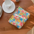 Quilted cotton pouch with colorful doodle patterns on a wooden table with coffee cup - Rainbow Smile Quilted