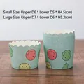 Set of 50 smiley face muffin liners in two sizes on a wooden tabletop display - Blue Smile Face