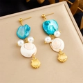 Detail of seashell earrings with blue stones, pearls, and gold-plated shell charms - Long Ocean Style Shell Earrings (E6231)