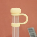 Pale yellow silicone straw cover cap for 10mm straws shown on a transparent straw - 10mm Straw Cap (Without Straw) / Cream Mushroom