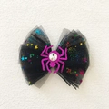 Close-up of Halloween bow hair clip with black mesh, sequins and pink glitter spider - Purple Spider Mesh Bow