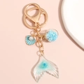 Detail view of ocean mermaid tail keychain with blue glitter and starry glass ball charm - Blue Glass Ball Shell Mermaid Tail Style (E4951)