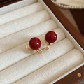 Detail of red round pearl ear clips with golden metal clamps in a jewelry box - Ear Clip-Gold-Red 10mm
