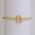 Elastic gold bead bracelet featuring an 18K gold-plated micro-pave zircon letter E charm - Letter E