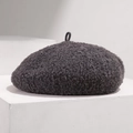Detailed texture of dark grey wool beret with plush finish on white podium - Adjustable / Gray