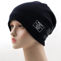Close-up of a navy blue knitted beanie with a rectangular white vintage patch detail - One Size / Navy Blue