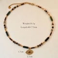 Macro view of evil eye tiger eye pendant with colorful beaded stainless steel chain - Beaded Eye Pendant