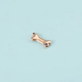 Detailed view of rose gold dog bone pendant with purple zircon and hanging loop - Rose Gold February