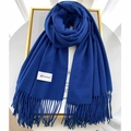 Deep blue cashmere feel scarf with fringe ends and Gerunsi brand label in soft lighting - Dark Blue