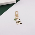 Close-up of golden panda keychain with bamboo charm and mahjong tile accessory - Panda with Mahjong