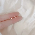 Detail view of 925 silver stud earrings featuring a minimalist abstract antler design - Moose Antlers / Silver
