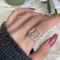 Minimalist silver sterling ring with oval hollow design worn on a model hand - JZ0325 (Interlaced Oval)
