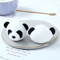 Close-up of plush panda head decorative accessories on a white plate with elegant props - 3D Panda Plush Head Accessory