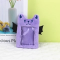 Detail view of purple plush photo card holder with black wings and cat ear design - Purple