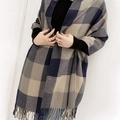 Plaid cashmere-like scarf with fringe in dark blue and beige, styled on a model - Blue and Grey Plaid