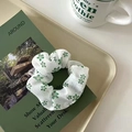 Floral scrunchie in white and green on a minimalist magazine for a stylish hair accessory look - Green Flower