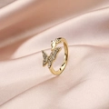 Detailed close-up of double butterfly rings with sparkling zircon inlay on gold band - Double Butterfly (Model H)
