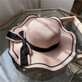 Light pink wide brim straw sun hat with black ribbon bow and dual-edged trim - One Size / Pink
