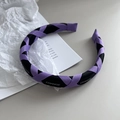 Detail of purple and black braided headband with white CHANGE lettering on fabric - Purple